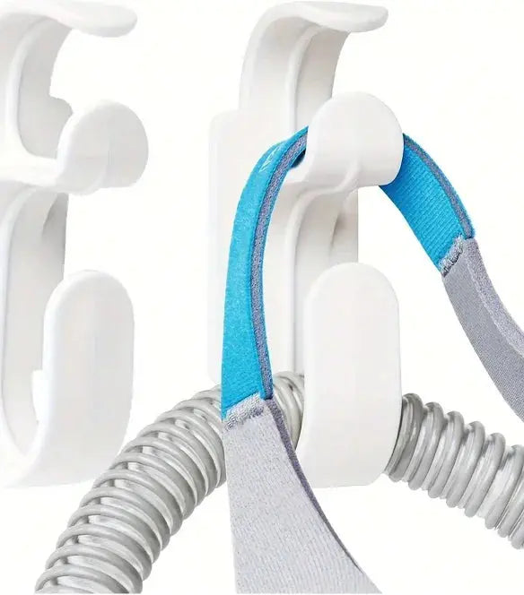 CPAP mask hanger with hose holder for convenient storage