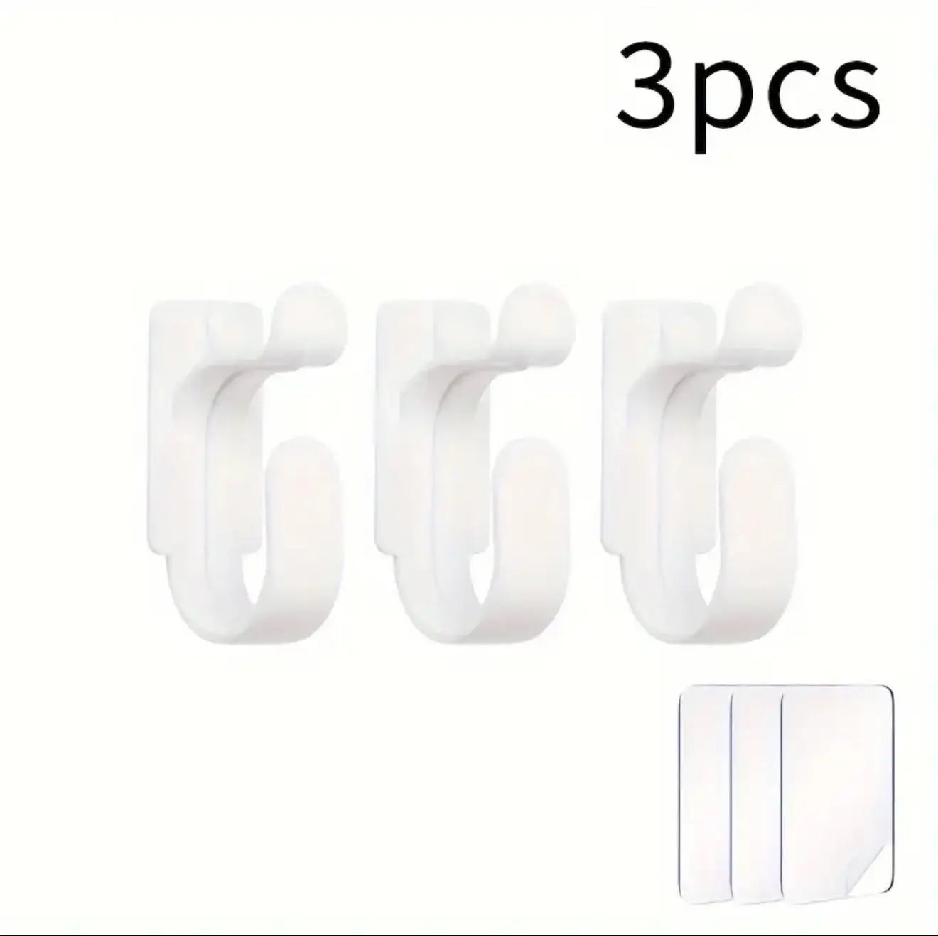 Three white hooks with a small adhesive strip on a white background