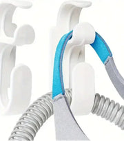 CPAP mask hanger with hose holder for convenient storage