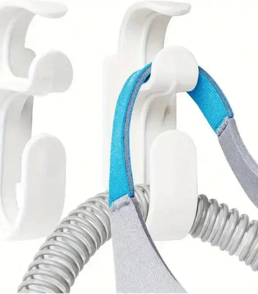 CPAP mask hanger with hose holder for convenient storage