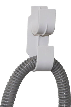 White hose holder with a coiled gray hose on a white background