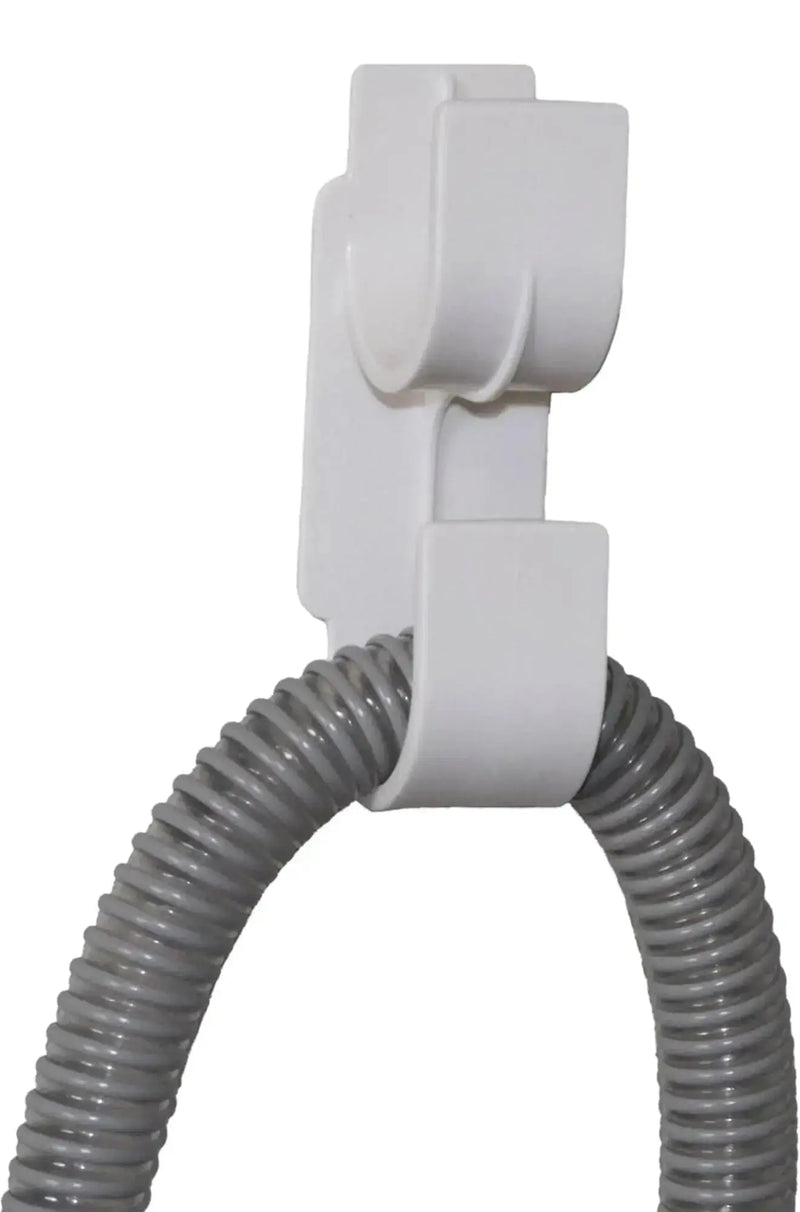 White hose holder with a coiled gray hose on a white background