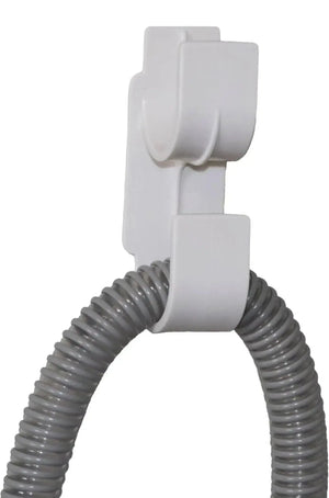White hose holder with a coiled gray hose on a white background