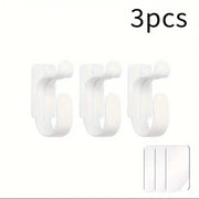 Three white hooks with a small adhesive strip on a white background