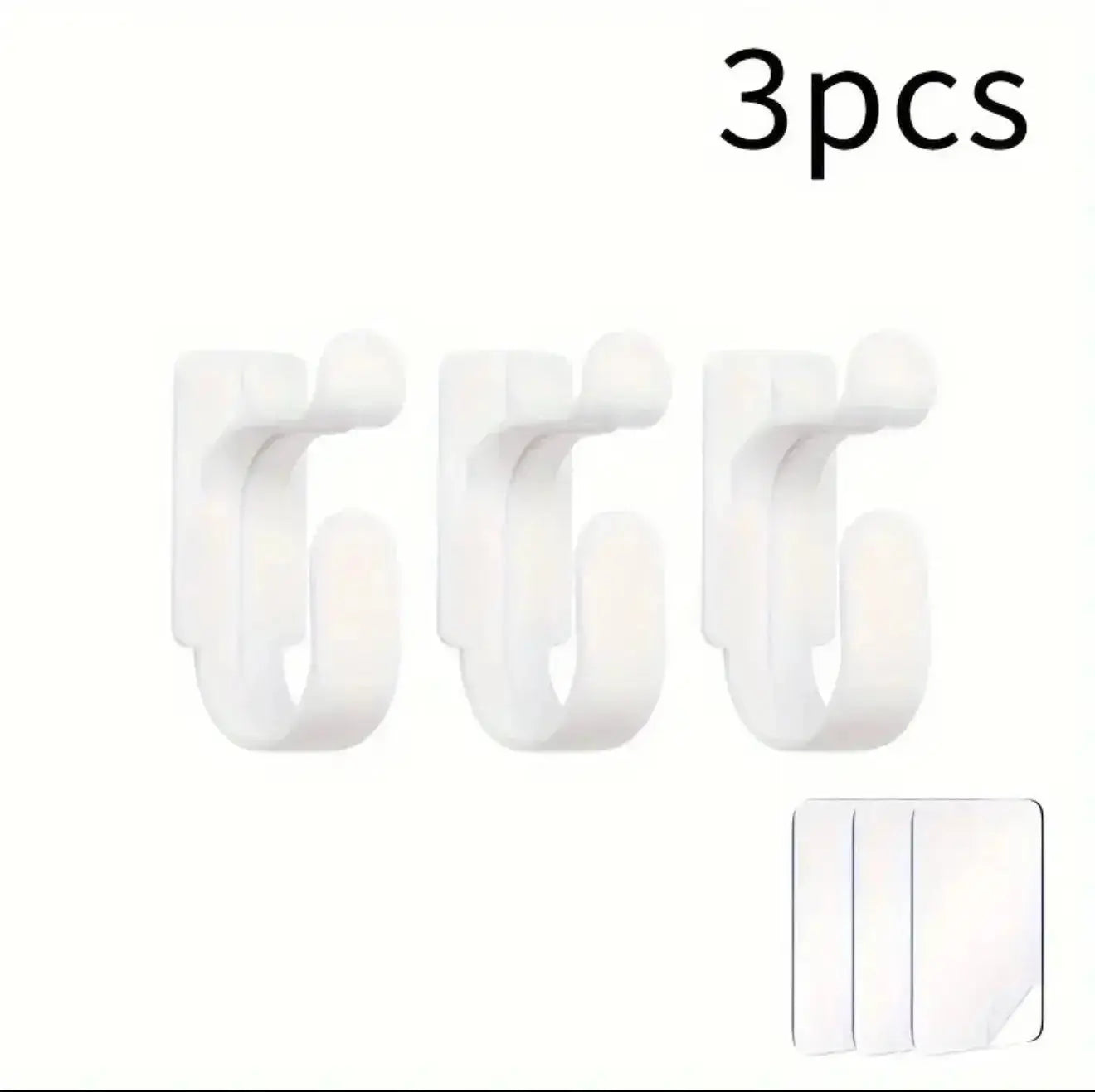 Three white hooks with a small adhesive strip on a white background