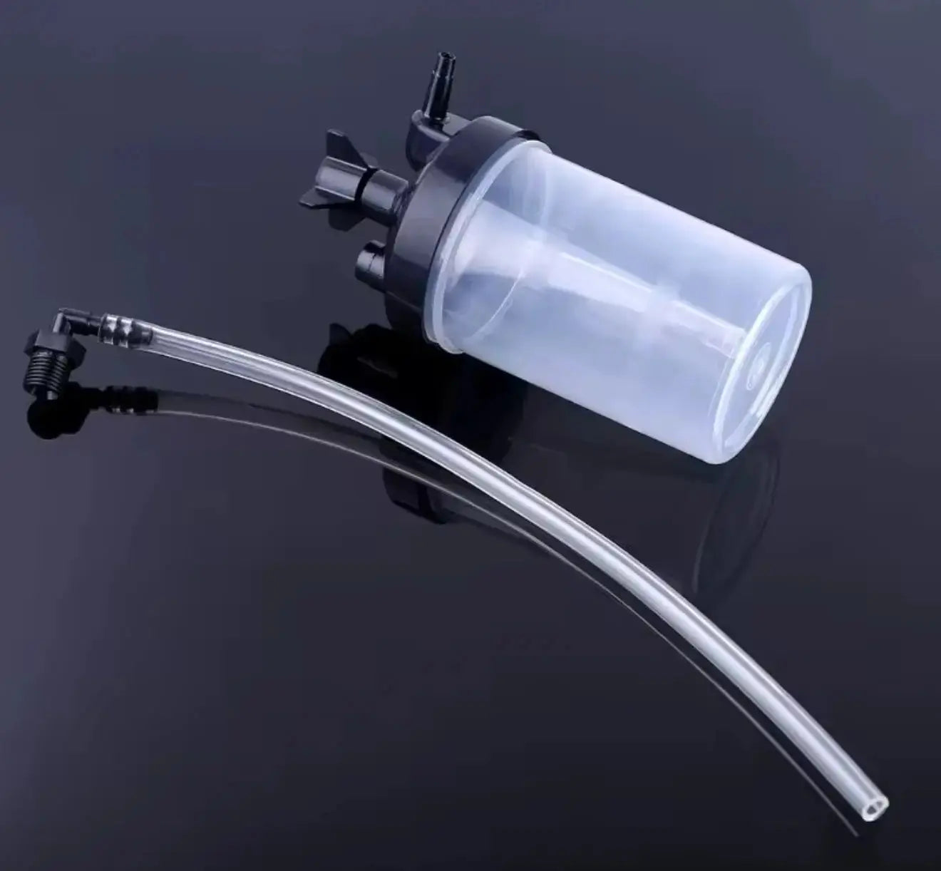 Clear plastic container with a long flexible tube on a black background