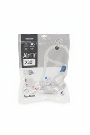 ResMed AirFit X30i oral nasal mask in its original retail packaging, placed on a dark gray textured carpet.